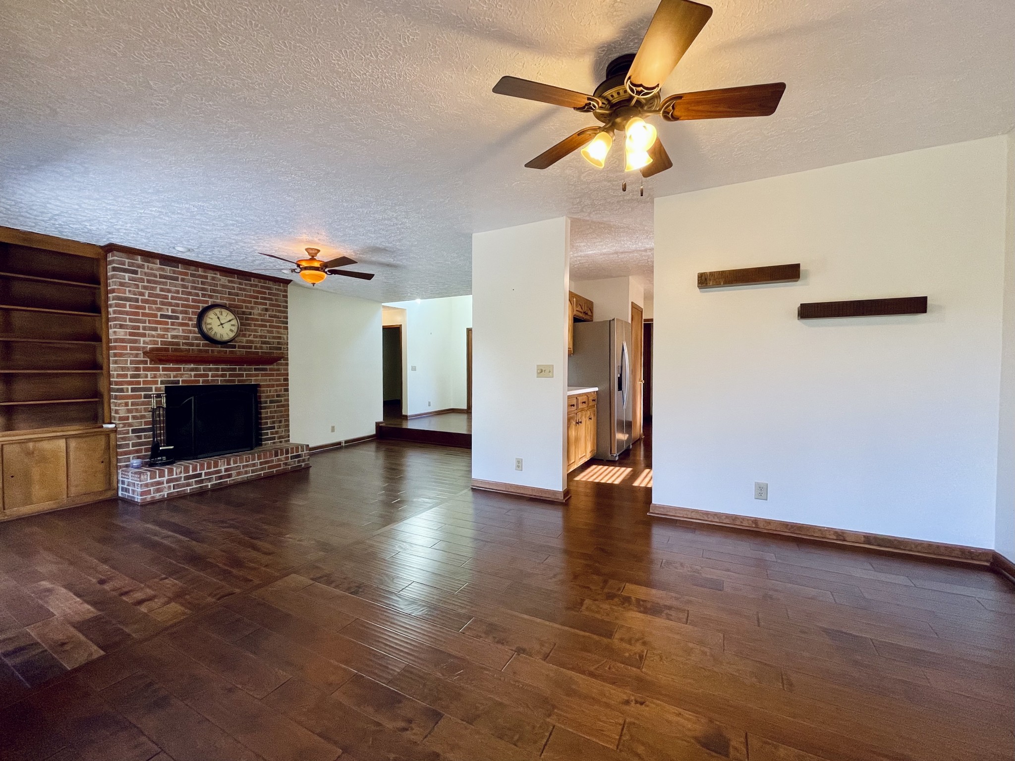 2911 New Hope Road Hendersonville, TN 37075 - Photo 9 of 27 a view of an empty room with wooden floor a fireplace and a window