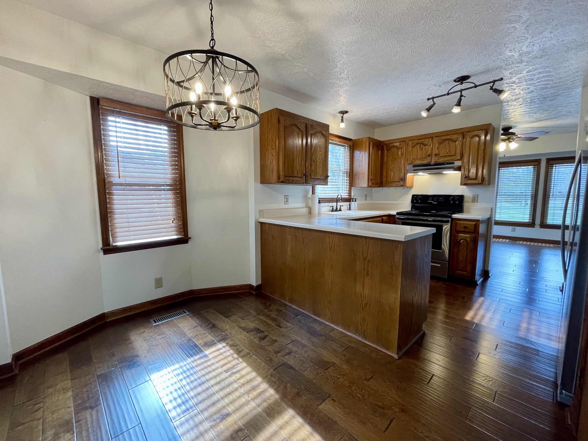 2911 New Hope Road Hendersonville, TN 37075 - Photo 10 of 27 a kitchen with stainless steel appliances granite countertop a stove top oven a refrigerator a dining table and chairs with wooden floor