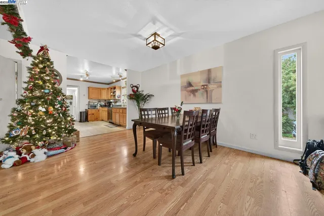 a view of a dining room with furniture and wooden floor