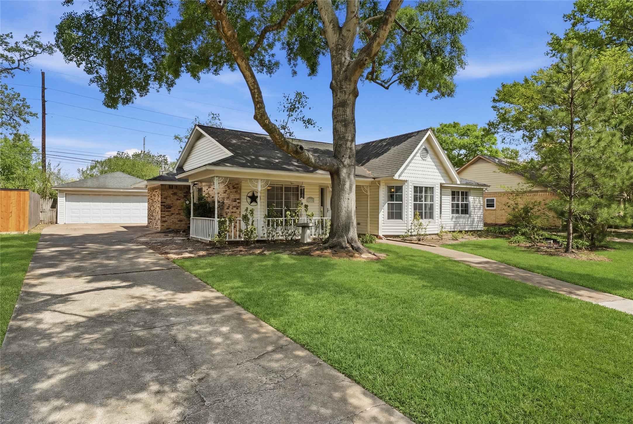 Charming single-story home with a welcoming front porch with plenty of room for your rocking chairs! Features a long driveway leading to a detached 2 car garage adding to the curb appeal.