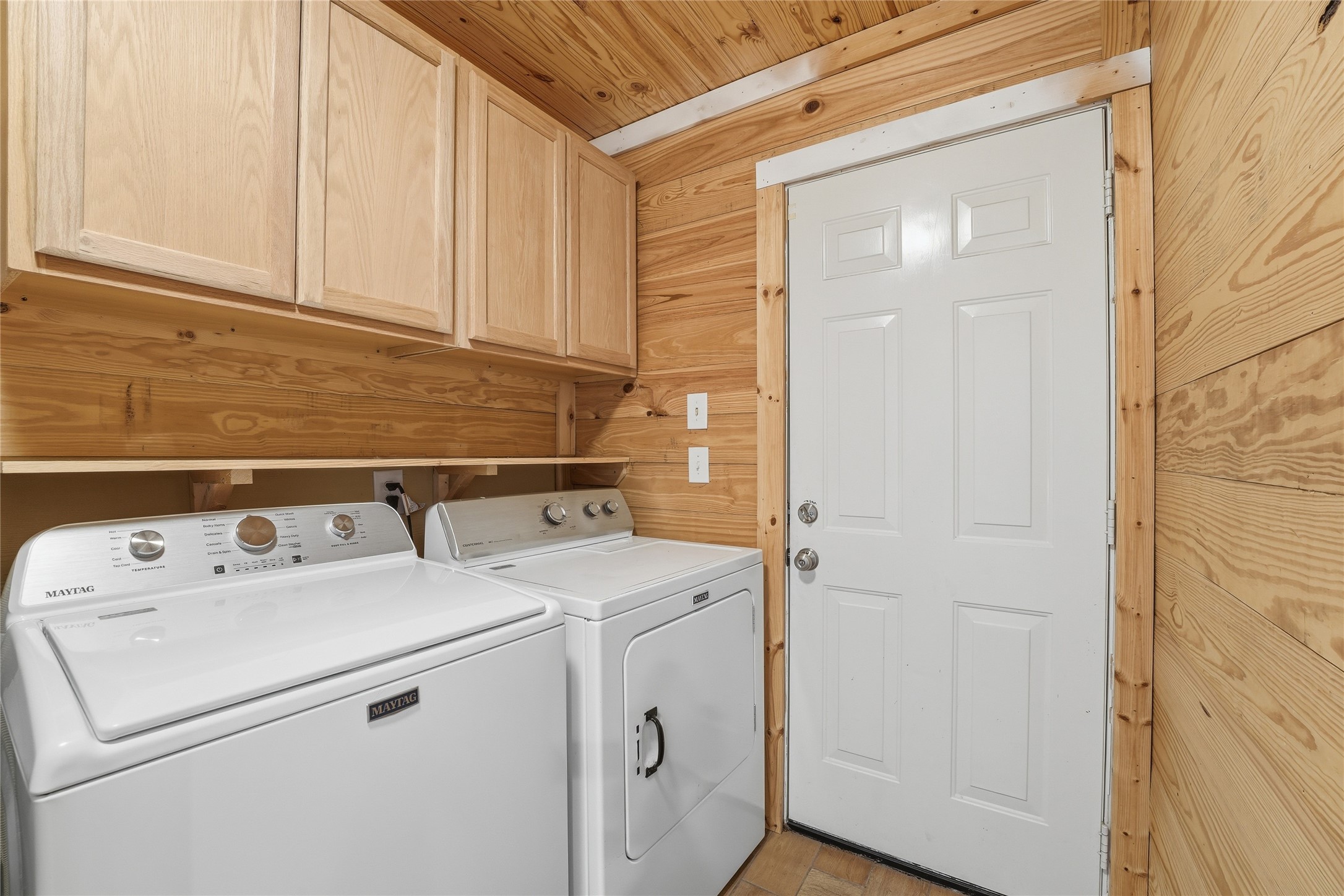 22338 Wetherburn Lane Katy, TX 77449 - Photo 18 of 36 Laundry room real wood walls, ample storage and access to the backyard. Washer and dryer can convey.
