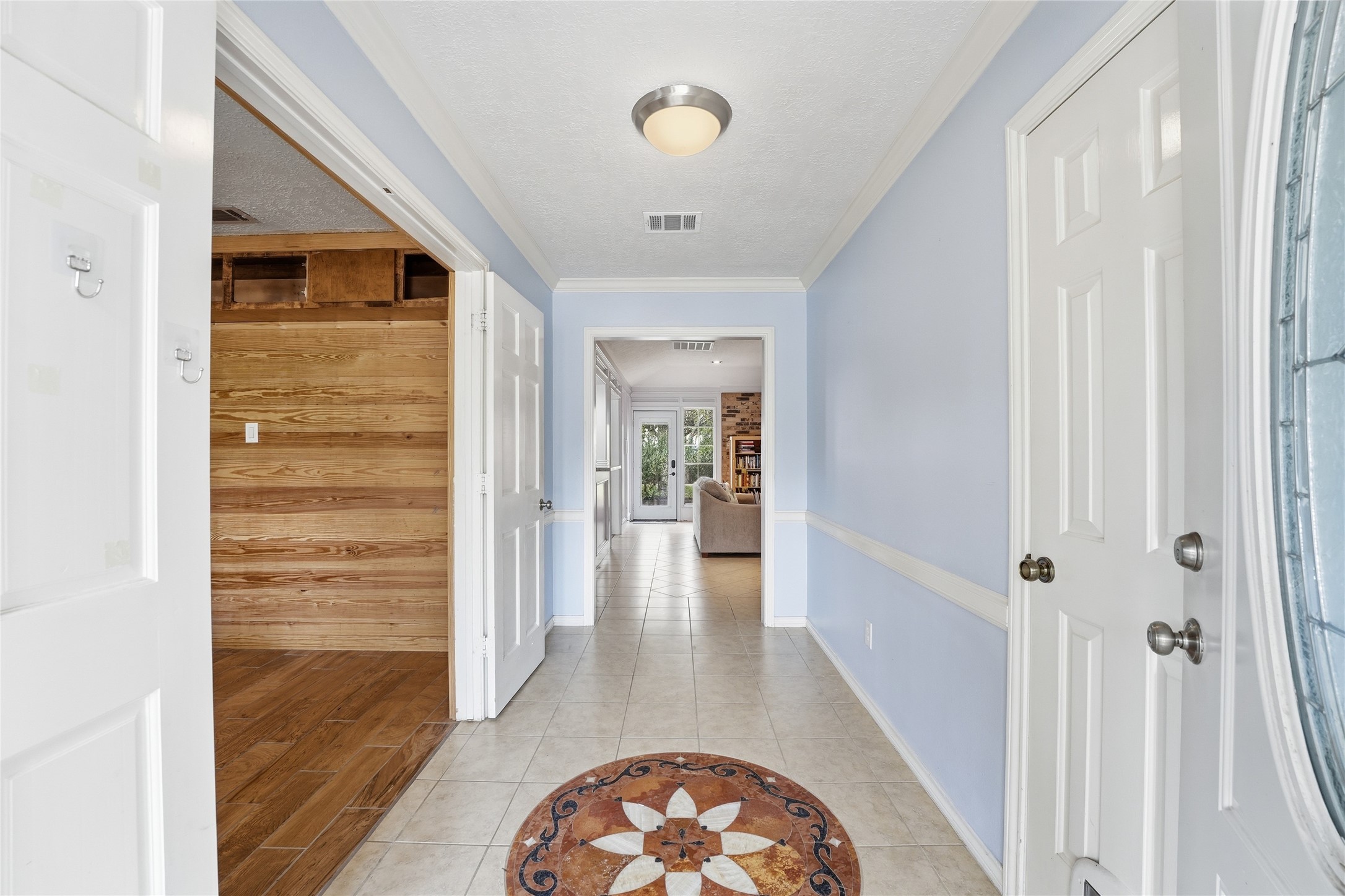 22338 Wetherburn Lane Katy, TX 77449 - Photo 3 of 36 Long entry to greet your guests with a view to the living room ahead and the office/bedroom with double doors on the left. Coat closet on the right.