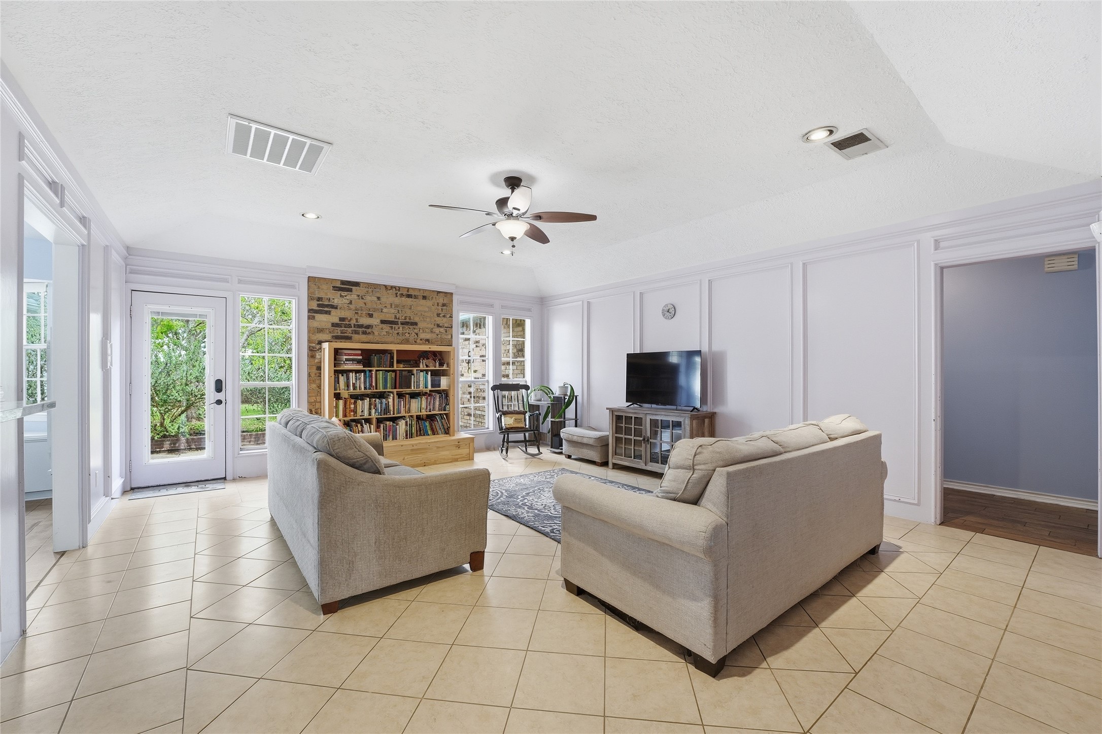 22338 Wetherburn Lane Katy, TX 77449 - Photo 6 of 36 Spacious living room with decorative wall moldings adding elevated look to the space. Vaulted ceilings add to the airy feel of the home.
