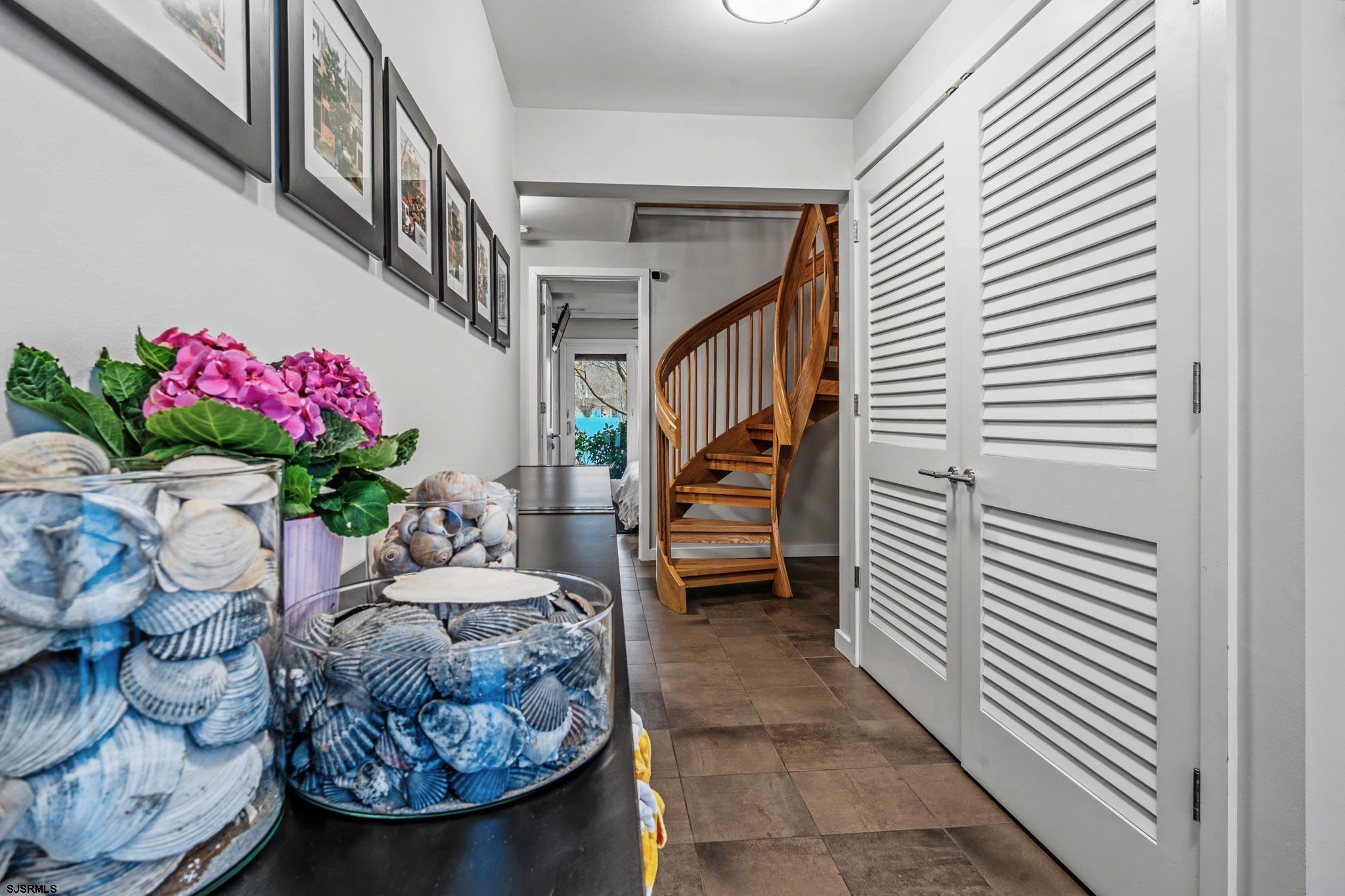 5 Beacon Lane Brigantine, NJ 08203 - Photo 5 of 39 a hallway with a flower pot and a fireplace