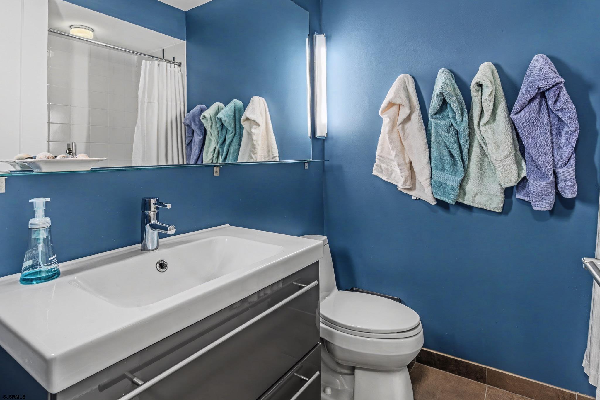 5 Beacon Lane Brigantine, NJ 08203 - Photo 8 of 39 a bathroom with a sink a toilet and a mirror
