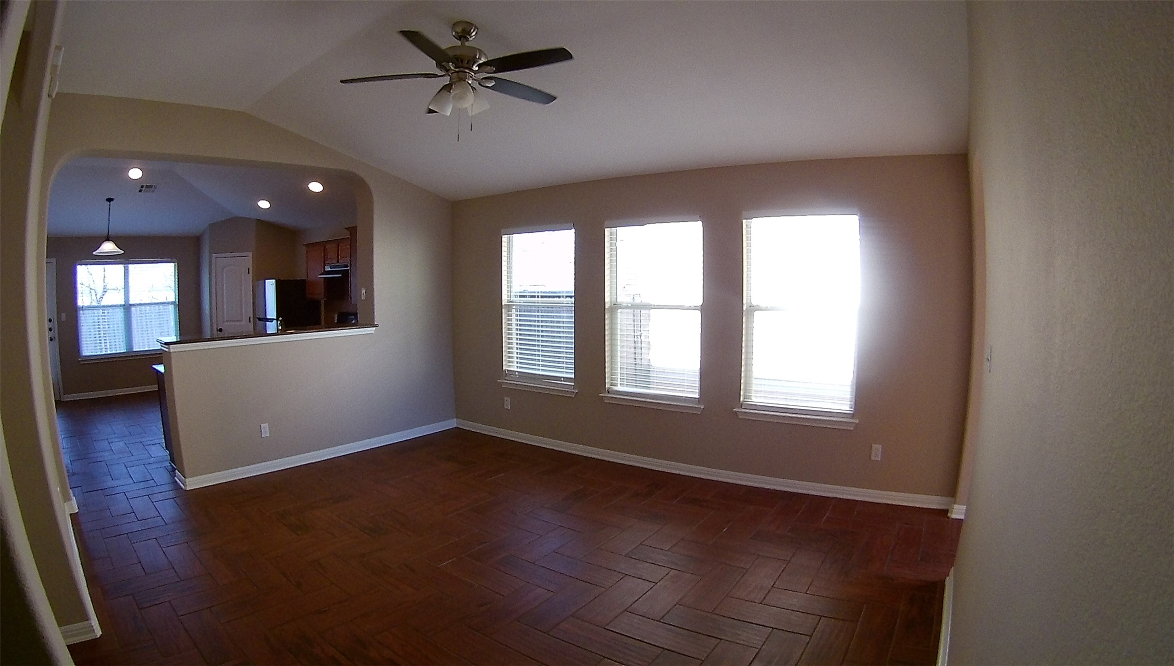 3304 Wickham Lane Austin, TX 78725 - Photo 3 of 13 Spare room with parquet floors, ceiling fan, and vaulted ceiling