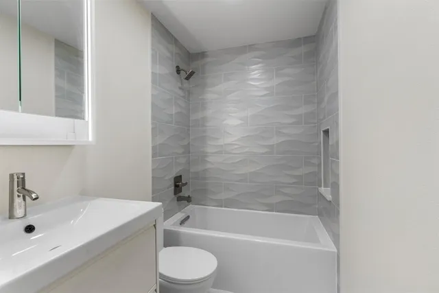 a bathroom with a sink a toilet and a bathtub