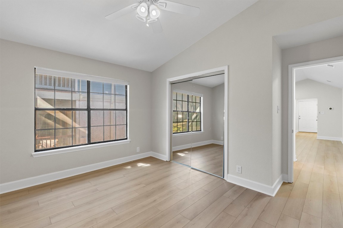 2215 Post Road, Unit 2051 Austin, TX 78704 - Photo 20 of 37 an empty room with wooden floor and windows