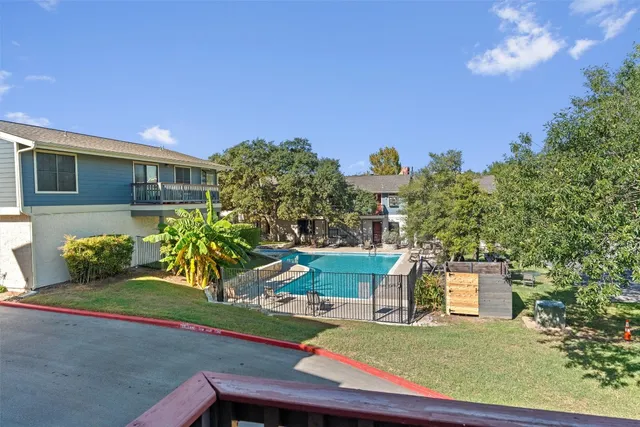 a view of a patio with chairs and plants