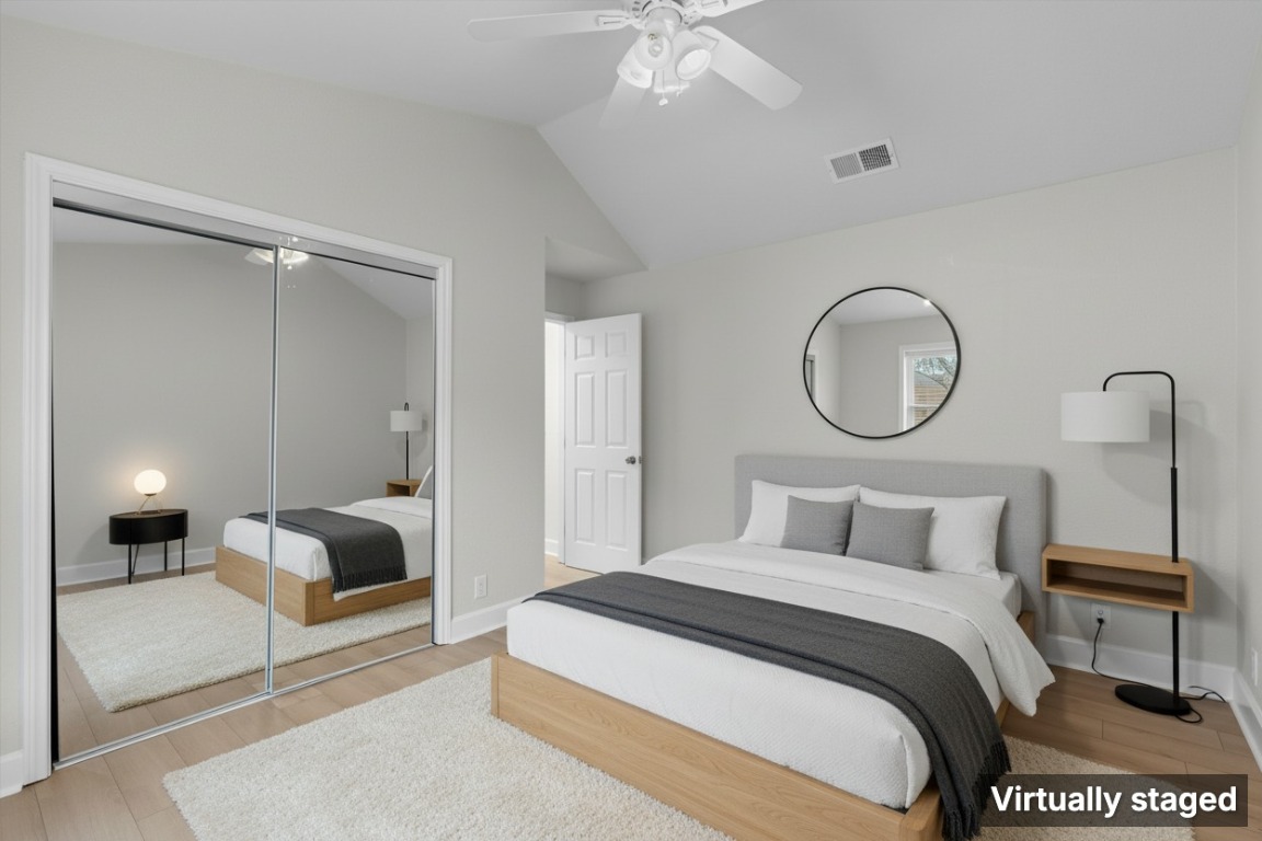 2215 Post Road, Unit 2051 Austin, TX 78704 - Photo 4 of 37 a bedroom with a bed a mirror and lamp