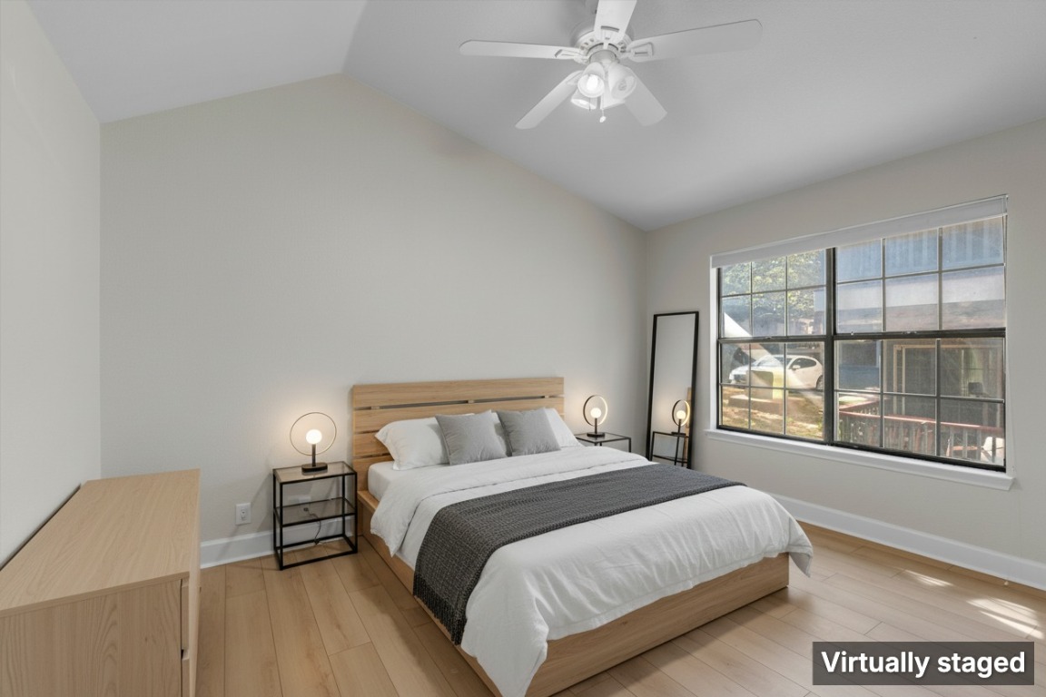 2215 Post Road, Unit 2051 Austin, TX 78704 - Photo 5 of 37 a bedroom with a large bed and a large window