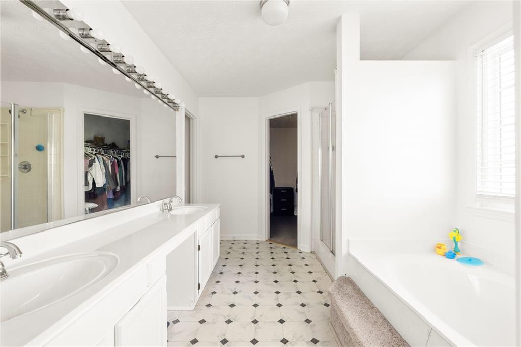 3384 Southern Oaks Court Decatur, GA 30034 - Photo 16 of 27 a hallway with a white cabinets a sink and a window