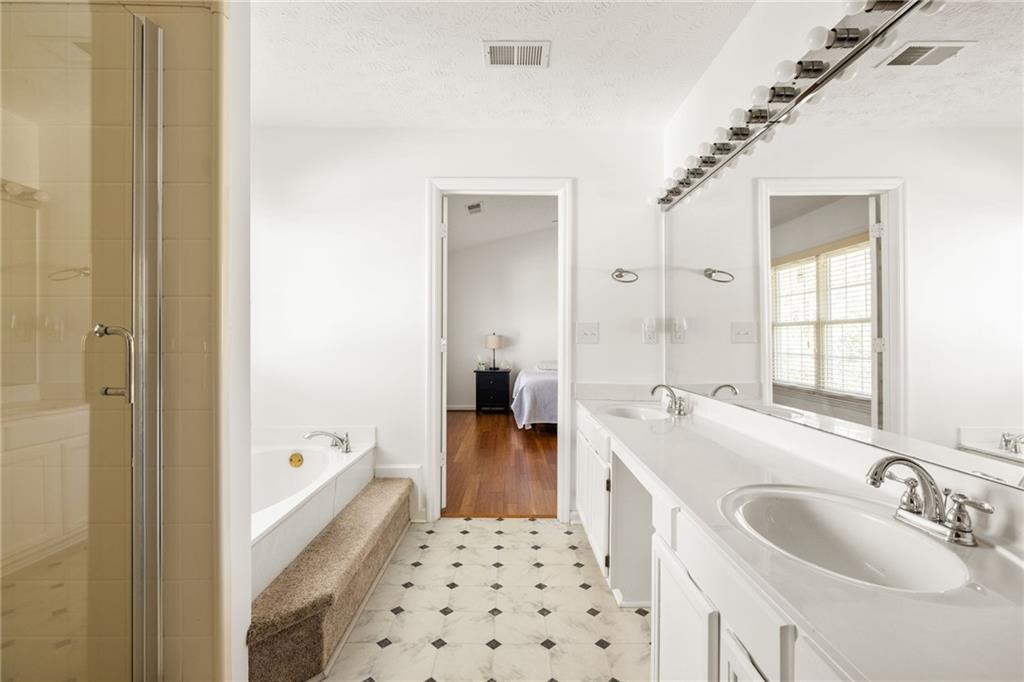 3384 Southern Oaks Court Decatur, GA 30034 - Photo 17 of 27 a en suite bathroom with a sink a tub and a mirror
