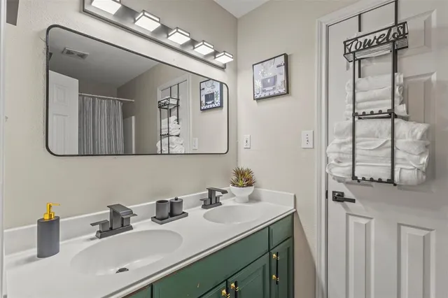 a bathroom with a sink vanity and a mirror