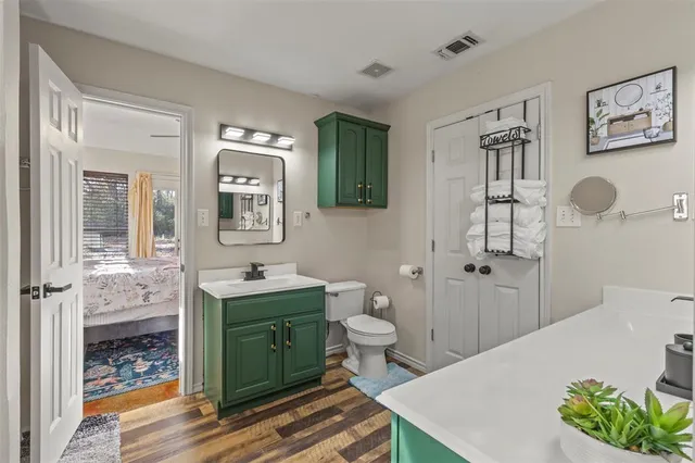a bathroom with a sink toilet and mirror