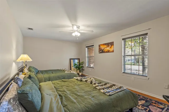 a bed sitting in a bedroom next to a window