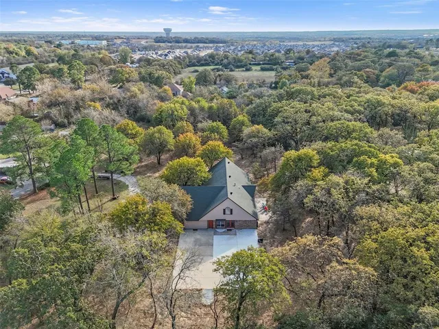 an aerial view of a house with a yard