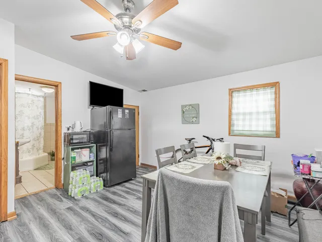 a living room with stainless steel appliances kitchen island granite countertop furniture and a window