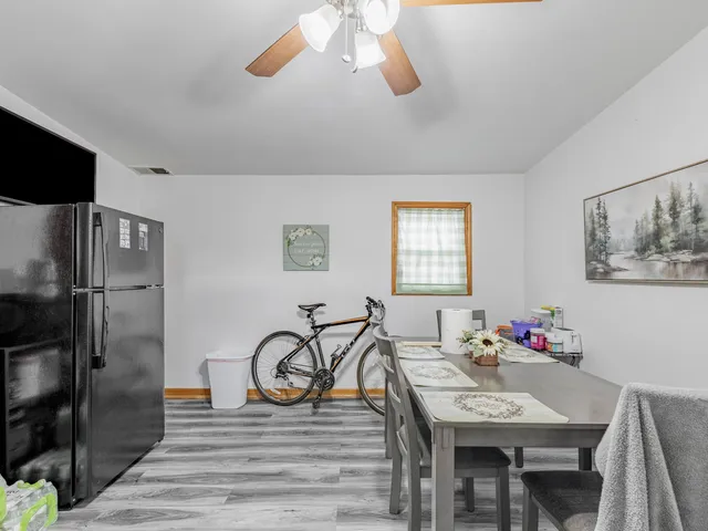a view of a dining room with furniture and a chandelier
