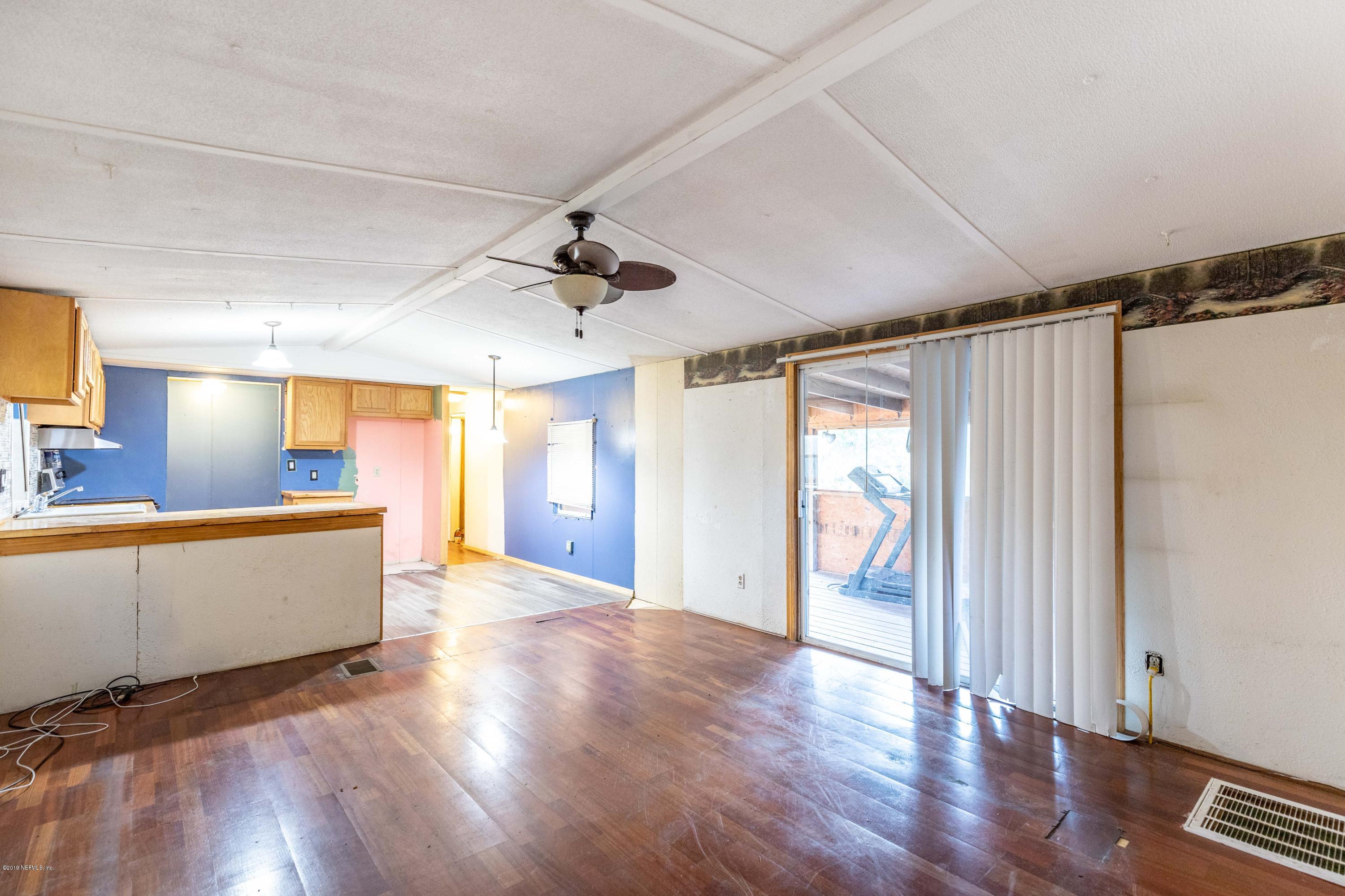 7840 Old Middleburg Road South Jacksonville, FL 32222 - Photo 20 of 46 a view of a big room with wooden floor and windows