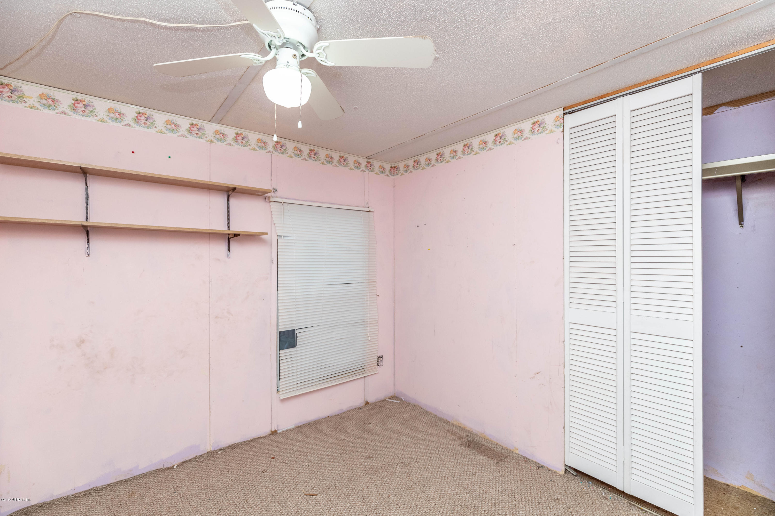 7840 Old Middleburg Road South Jacksonville, FL 32222 - Photo 24 of 46 a view of a room with a ceiling fan and a window