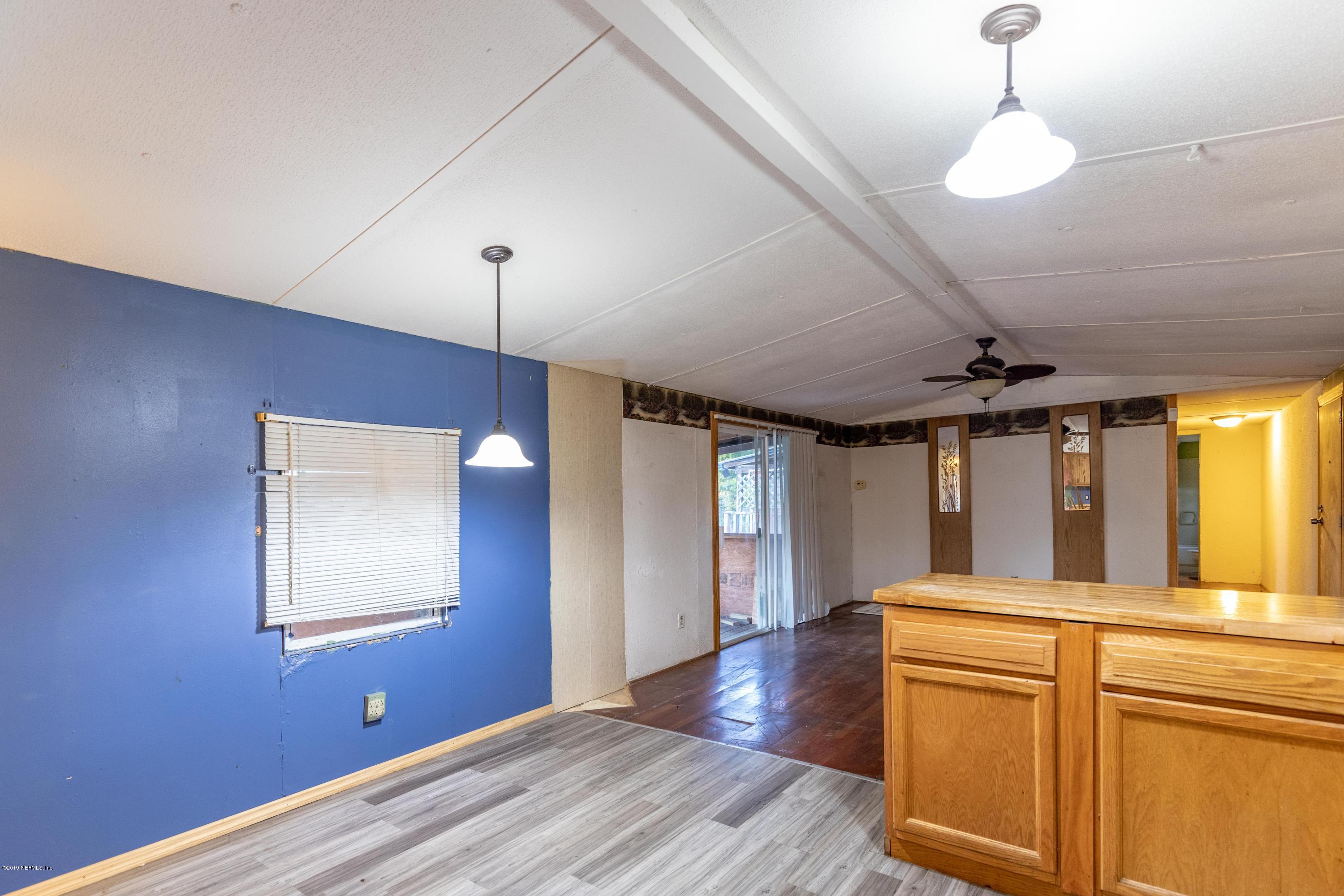7840 Old Middleburg Road South Jacksonville, FL 32222 - Photo 33 of 46 a view of a kitchen with wooden floor and a window