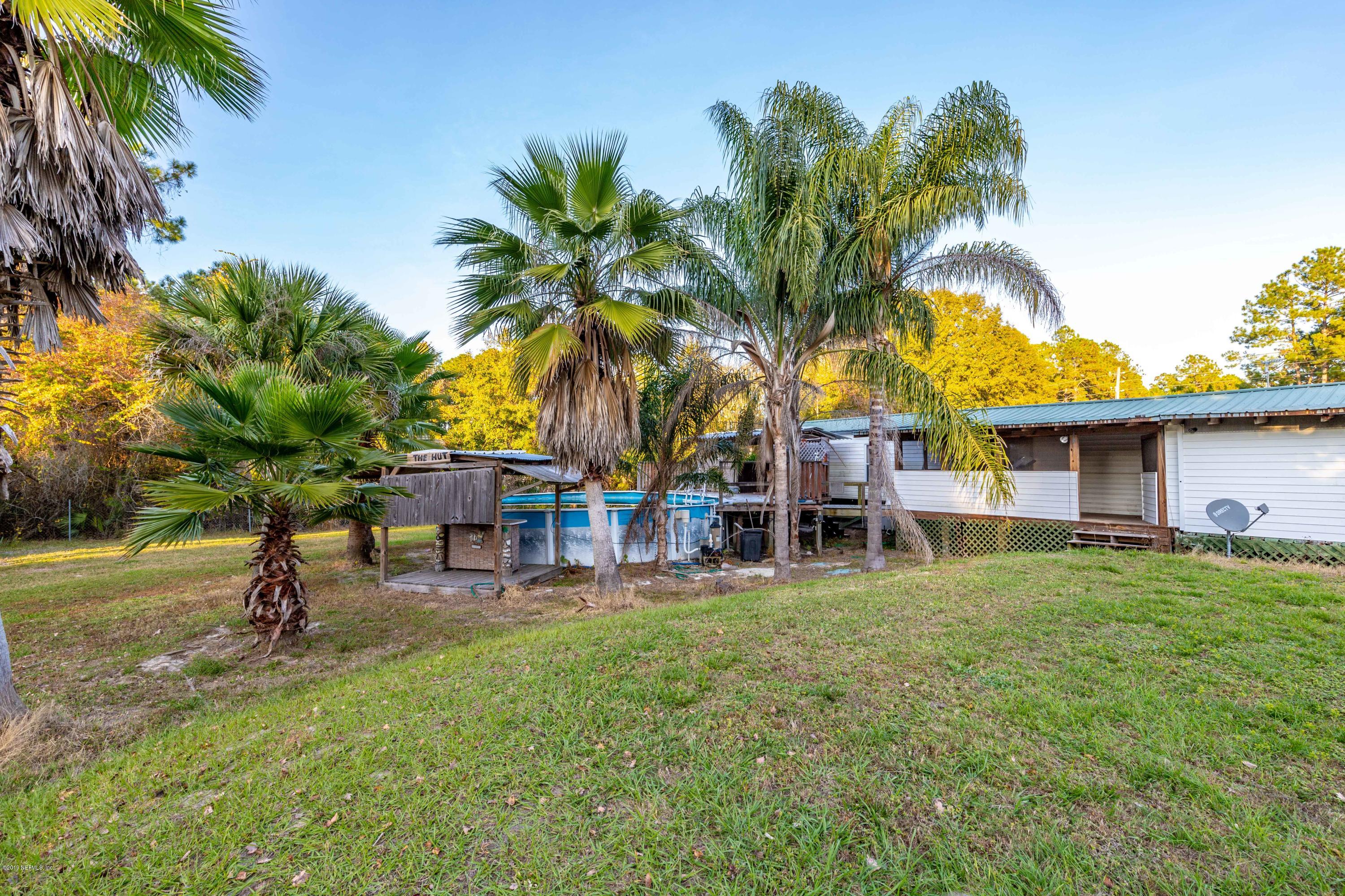 7840 Old Middleburg Road South Jacksonville, FL 32222 - Photo 39 of 46 a view of a house with a yard and palm trees
