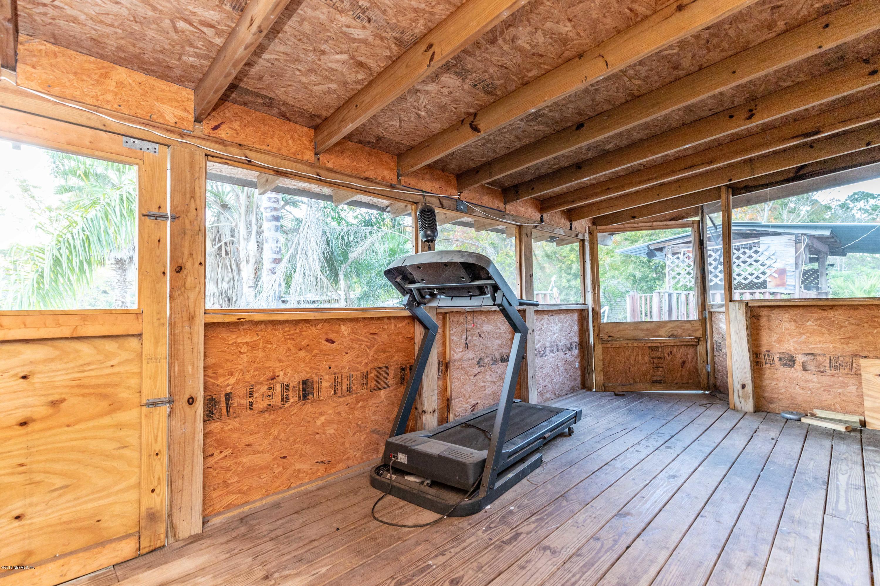 7840 Old Middleburg Road South Jacksonville, FL 32222 - Photo 40 of 46 a room with gym equipment and wooden floors