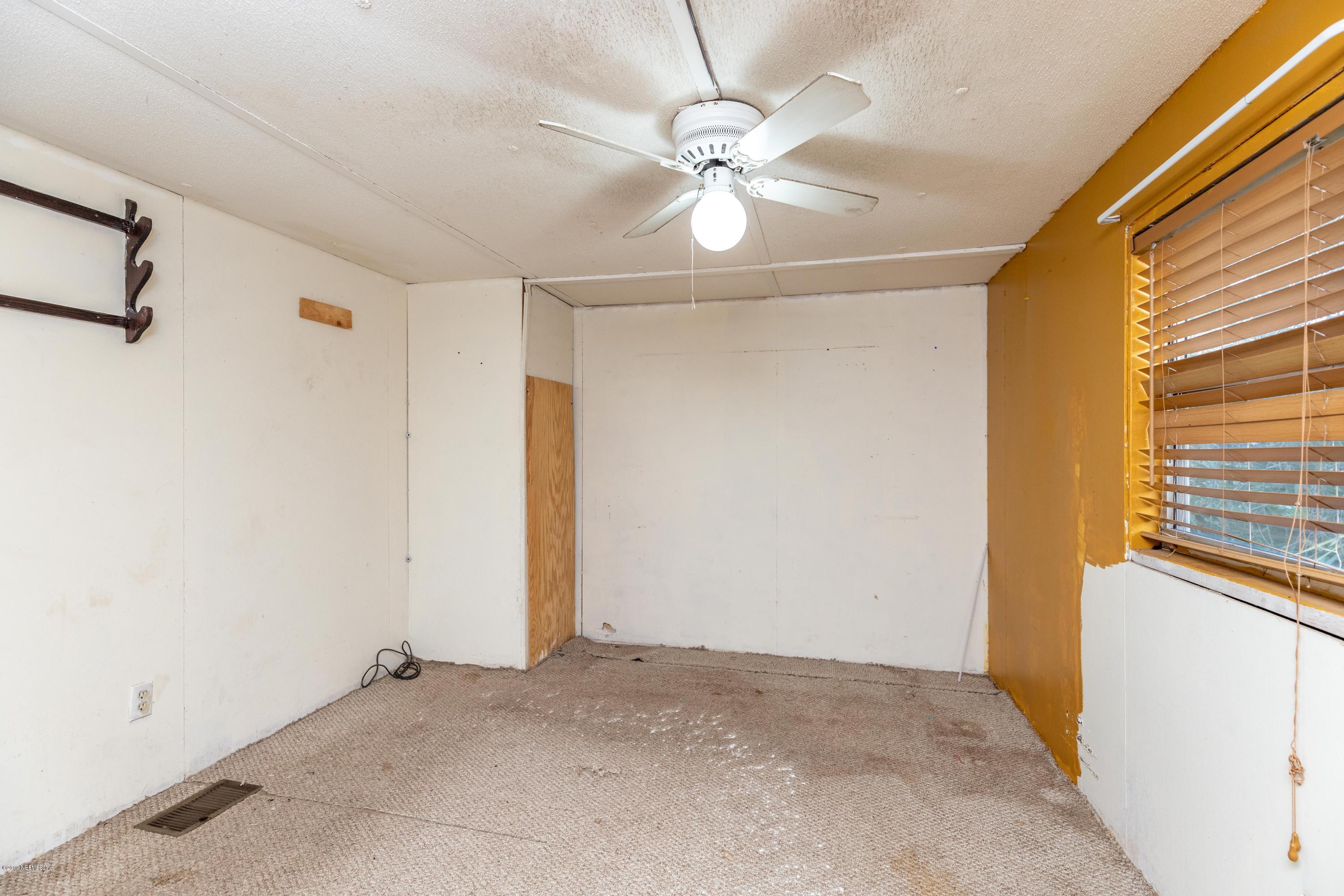 7840 Old Middleburg Road South Jacksonville, FL 32222 - Photo 6 of 46 a view of a livingroom with a ceiling fan and window