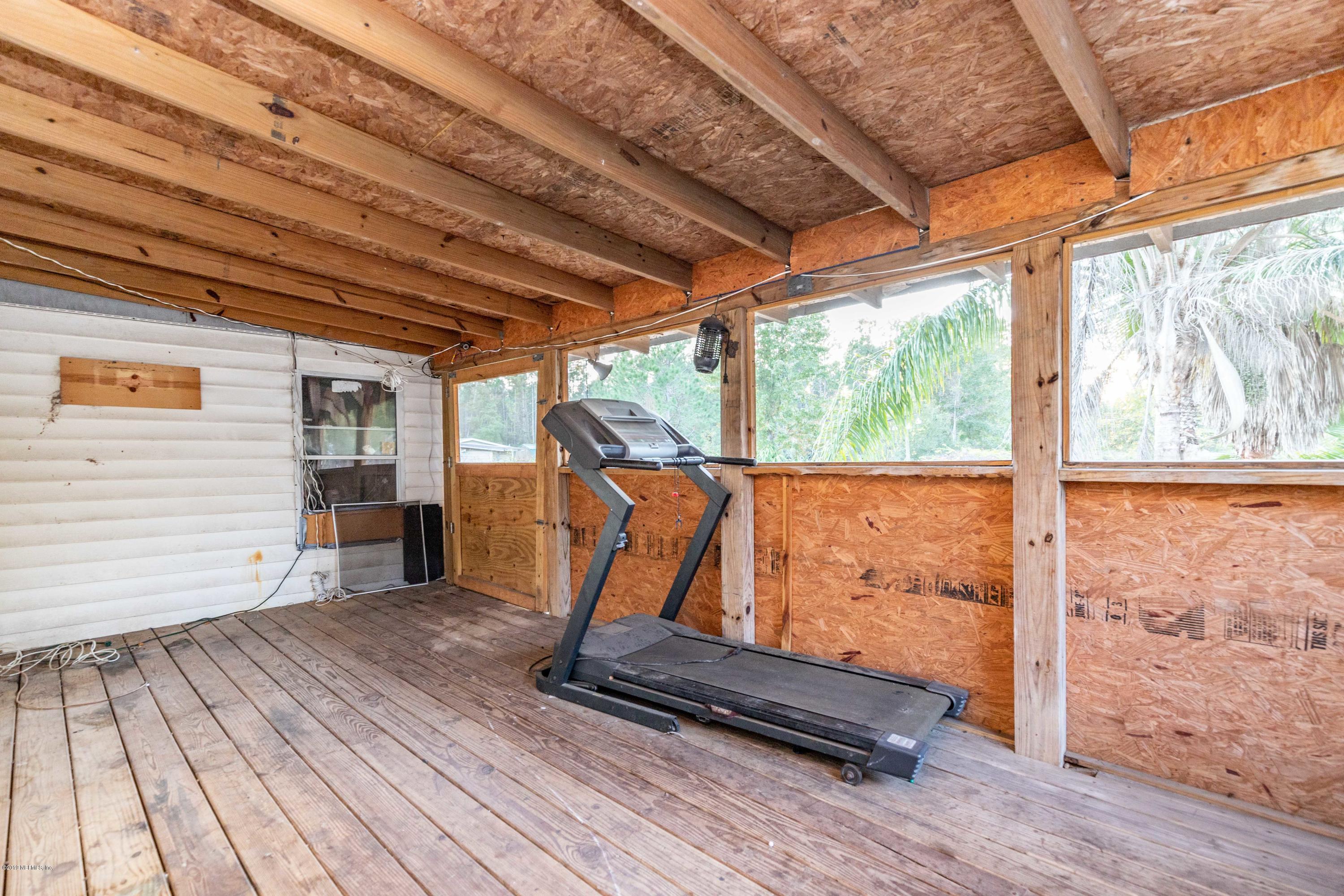 7840 Old Middleburg Road South Jacksonville, FL 32222 - Photo 10 of 46 a view of an empty room with wooden floor and windows
