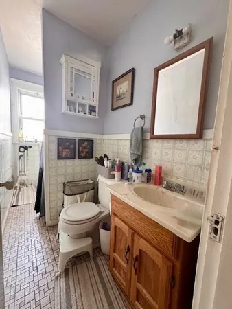 a bathroom with a sink toilet and mirror