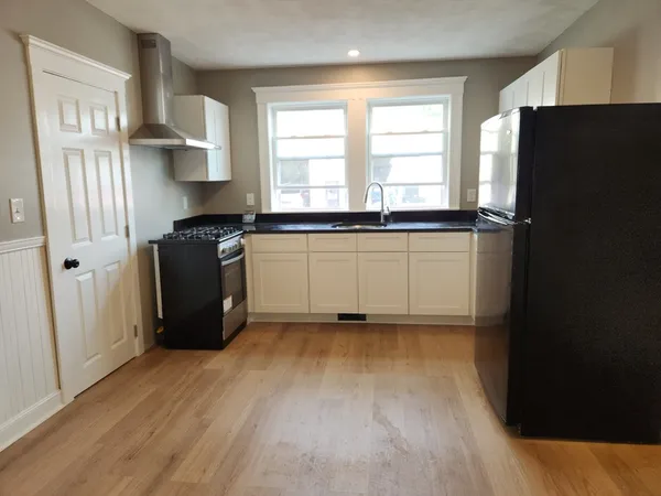 a kitchen with stainless steel appliances a refrigerator and a sink