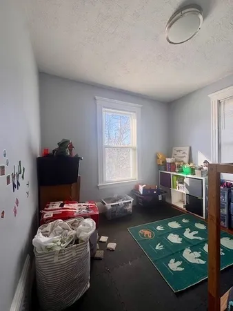 a bedroom with furniture and a window