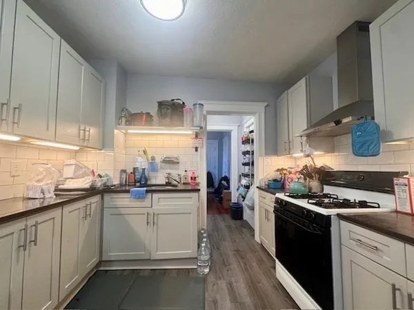 a kitchen with a sink stove and cabinets