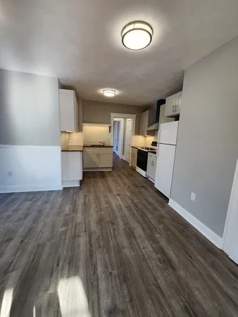 a kitchen with sink cabinets and wooden floor