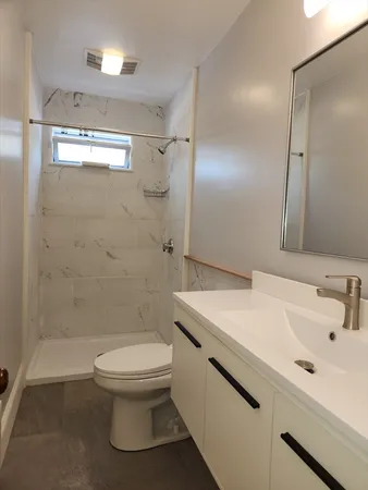 a bathroom with a sink toilet and shower