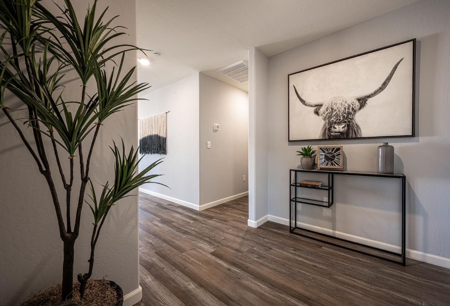 82 River Oak Court, Unit 48 Merced, CA 95341 - Photo 19 of 19 a view of a hallway with wooden floor and glass top table