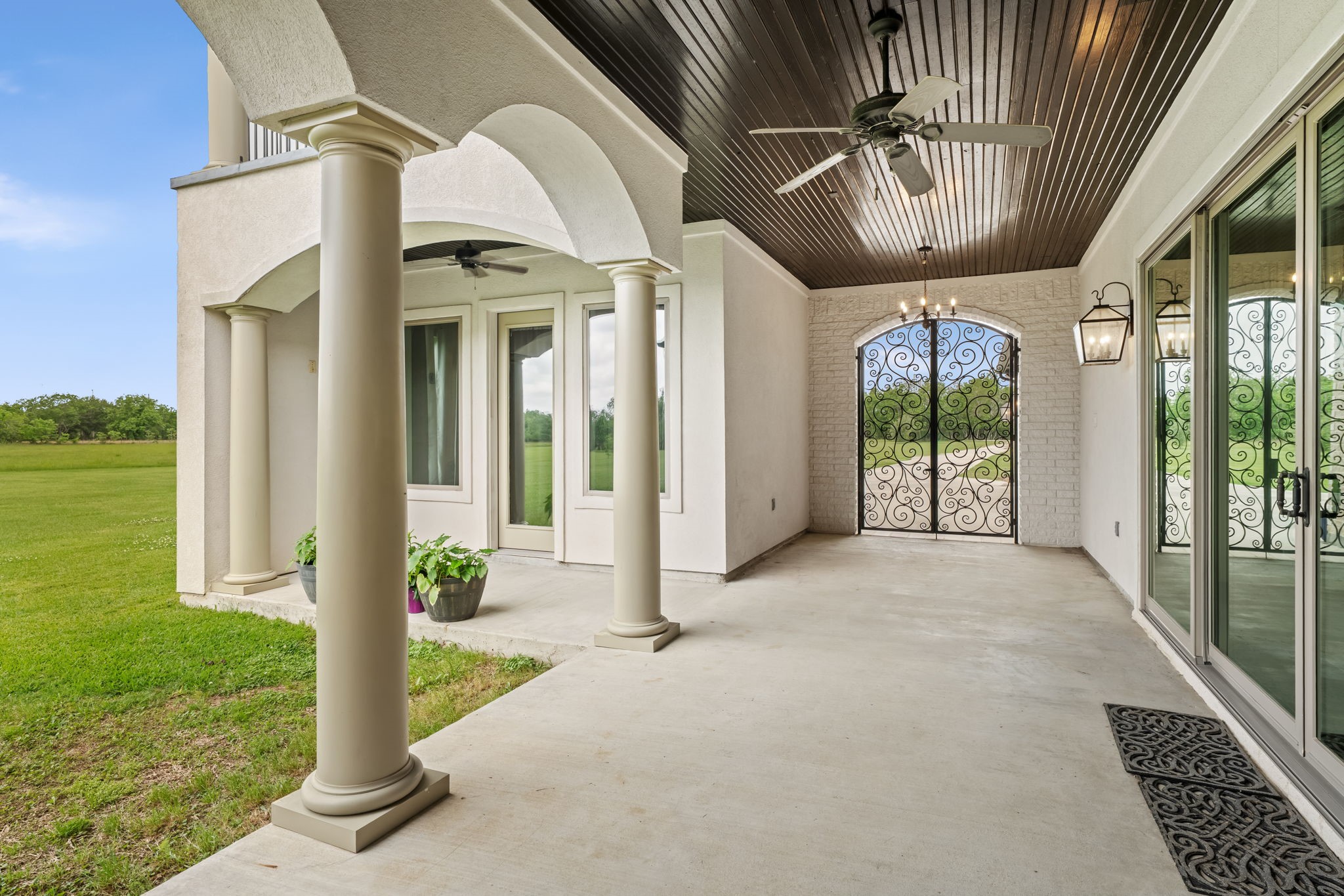 2856 Wolcek Road Crosby, TX 77532 - Photo 40 of 48 Outside, to the left in the image of the spacious covered patio with elegant columns, is a very private (outside access only) in-law/guest suite.