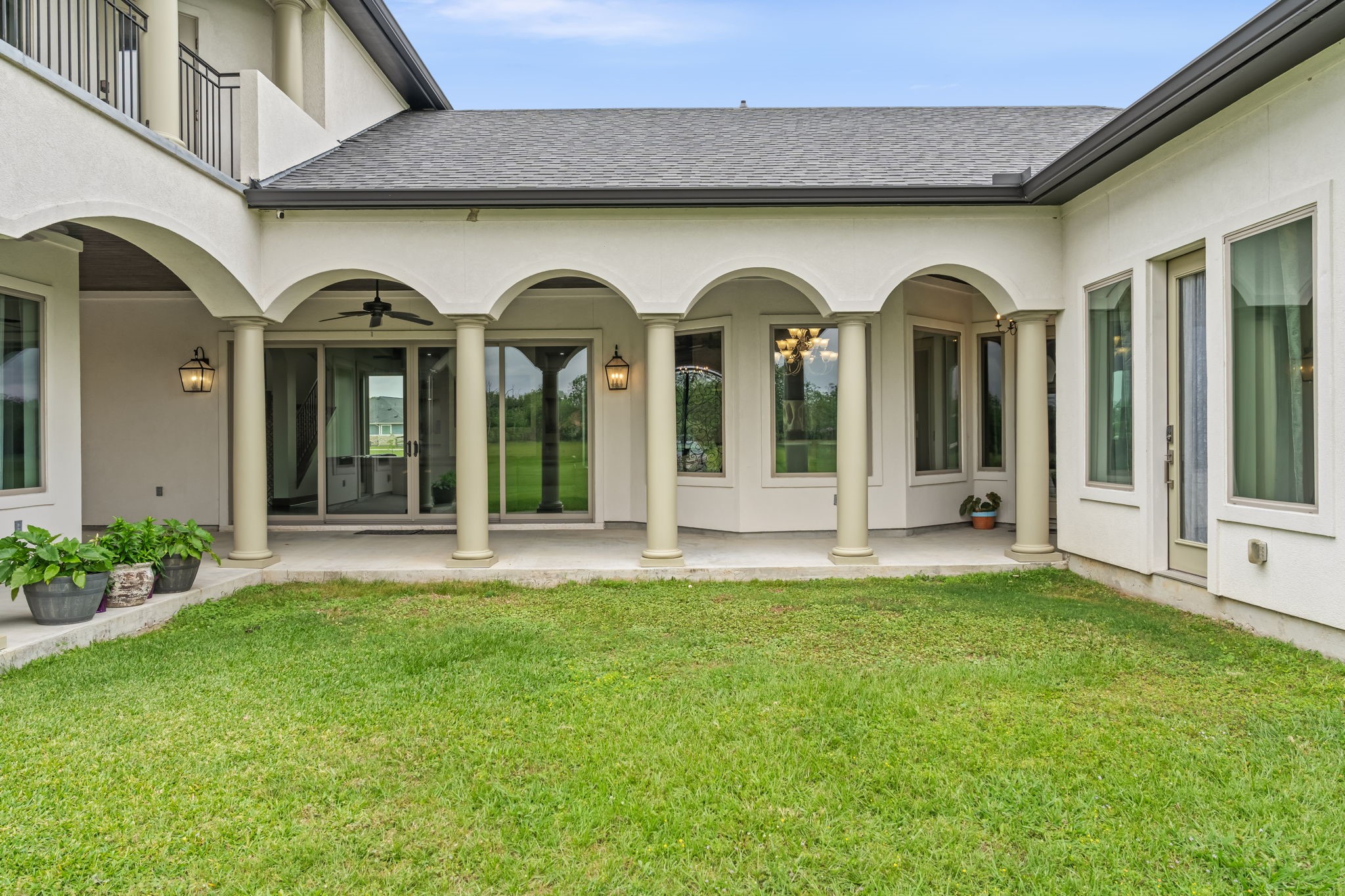 2856 Wolcek Road Crosby, TX 77532 - Photo 8 of 48 This home features a charming courtyard with arched columns and a covered patio area. Large windows and glass doors offer plenty of natural light and a seamless indoor-outdoor transition. Ideal for relaxation and entertaining. There is an electrical rough-in for a pool addition located in this area. The sellers have builder plans for the pool addition.