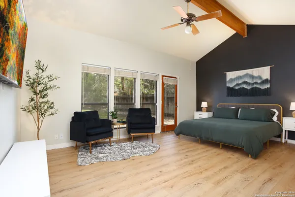 a bedroom with furniture and large windows