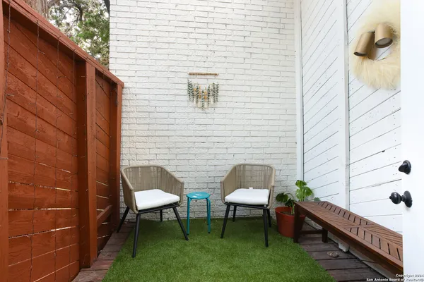 a balcony with table and chairs