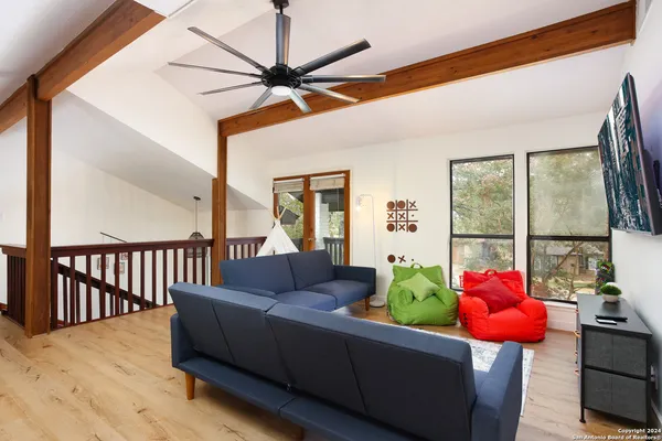 a living room with furniture fireplace and a large window