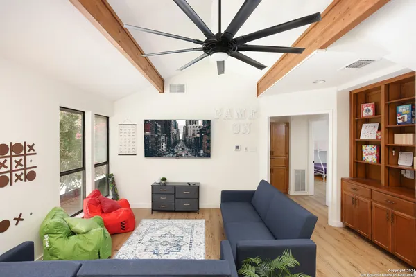 a living room with furniture and wooden floor