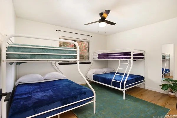 a bedroom with two bunk beds and a chandelier