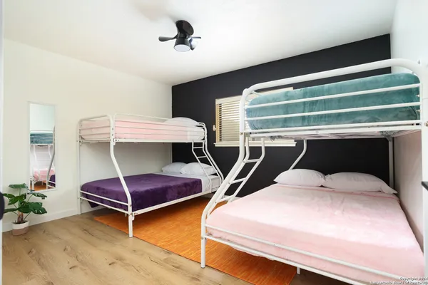 a bedroom with two beds and painted walls