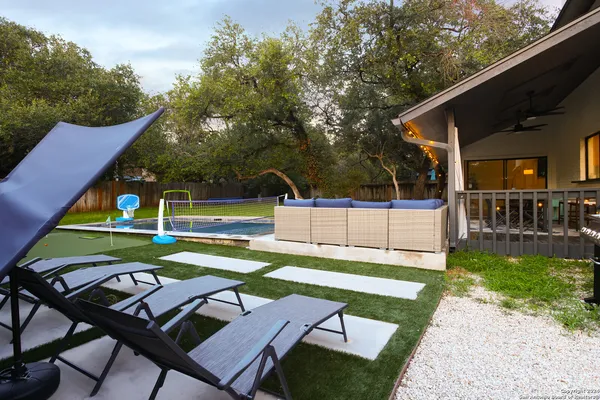 a view of a chairs and table in the backyard