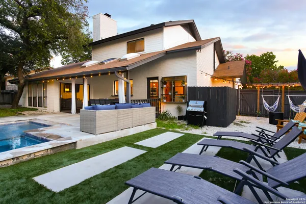a view of a patio with couches chairs and a yard