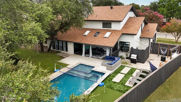 aerial view of a house with swimming pool and porch