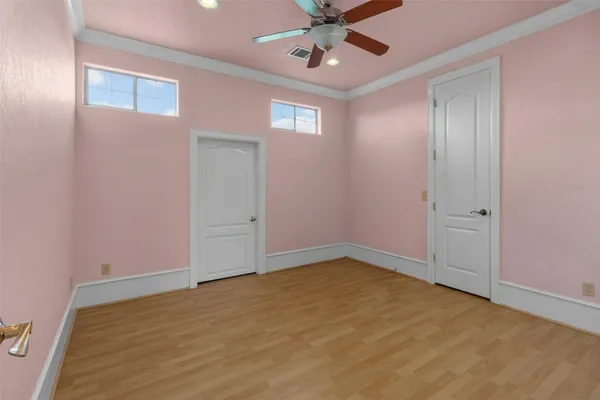 an empty room with windows and closet