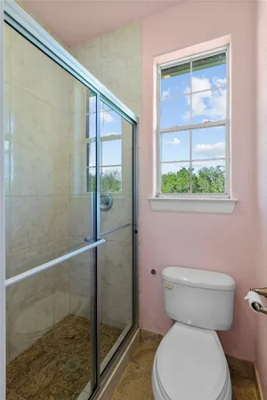 a white toilet sitting next to a bathroom sink